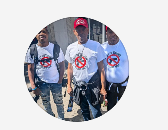 Three Haitian Taskforce members in 'Stop the Violence, Reclaim Haiti' t-shirts.